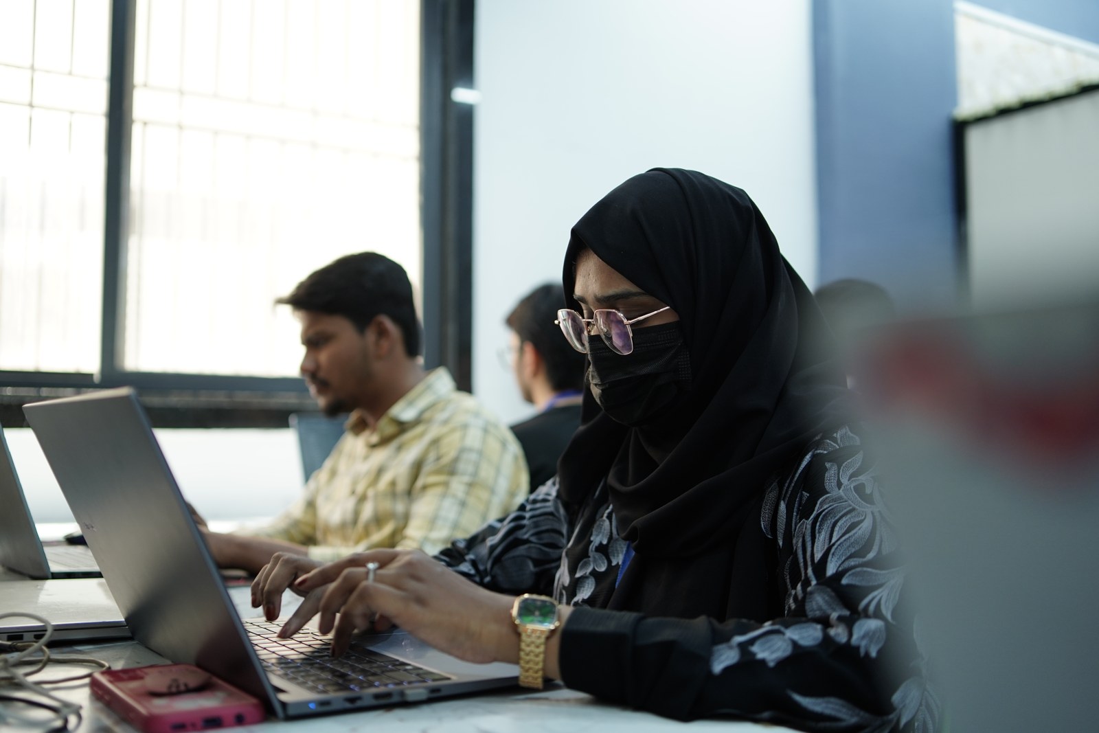 Students practising at laptops during a Faimsoft Academy class